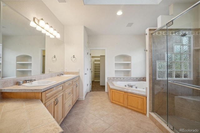 bathroom featuring plus walk in shower, tile patterned floors, built in features, and vanity