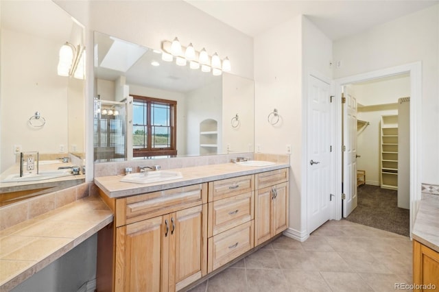 bathroom featuring tile patterned floors, plus walk in shower, and vanity