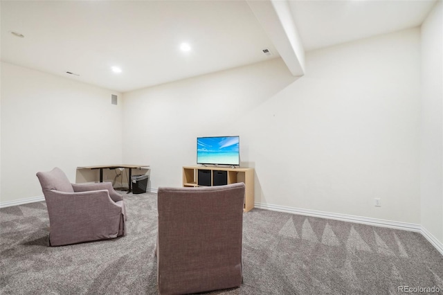 living room featuring beamed ceiling and carpet flooring