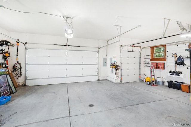 garage with electric panel and a garage door opener