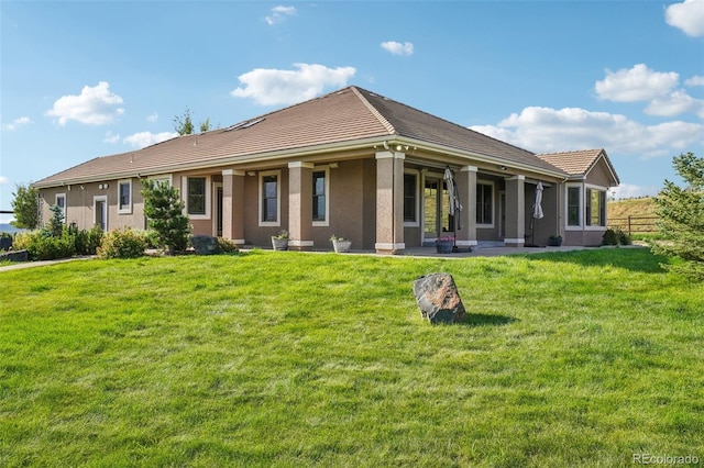 back of house with a lawn