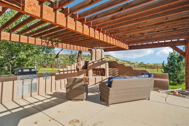 view of patio featuring exterior kitchen, an outdoor living space, a grill, and a pergola