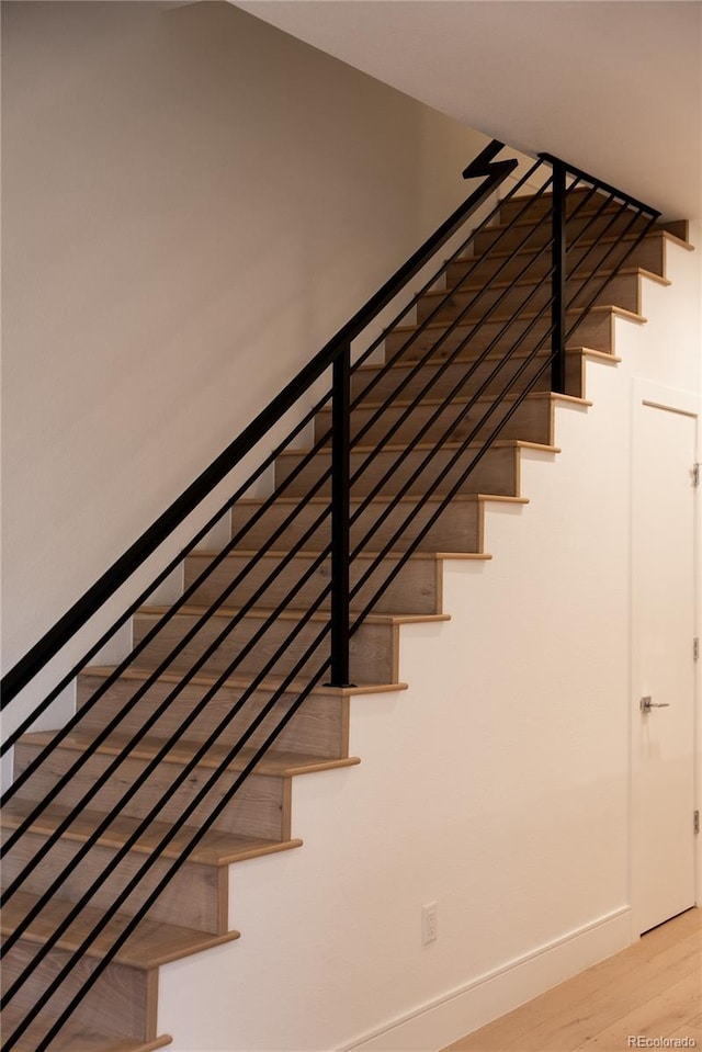 stairs with hardwood / wood-style floors