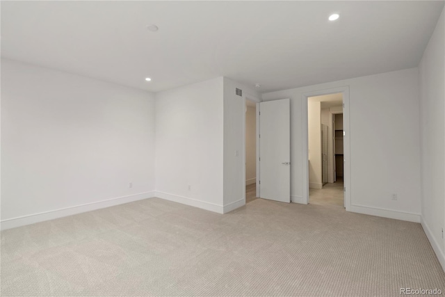 unfurnished room with light colored carpet