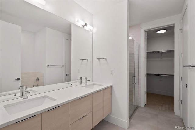 bathroom featuring vanity, tile patterned floors, and walk in shower