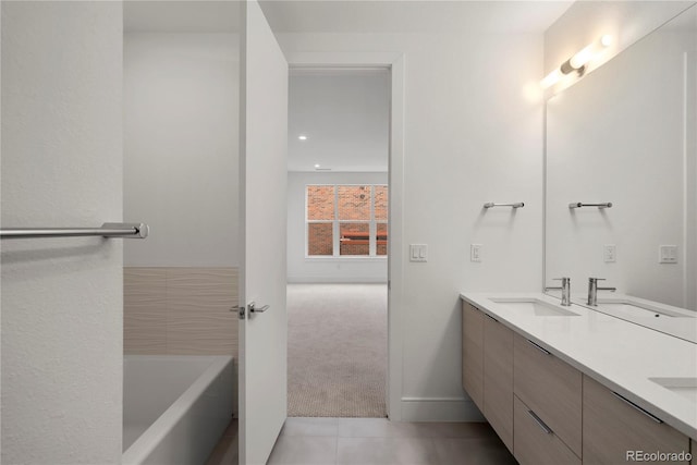 bathroom featuring vanity, a bath, and tile patterned flooring