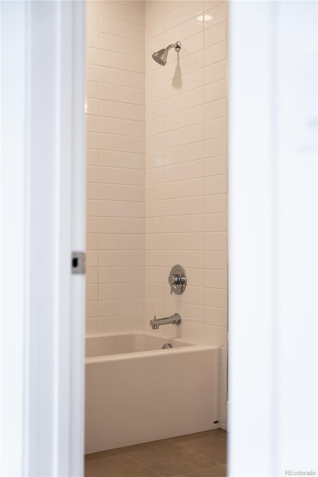 bathroom featuring tile patterned flooring and tiled shower / bath combo