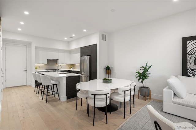 dining room featuring visible vents, recessed lighting, and light wood-style floors