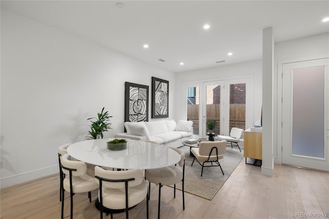 dining room featuring recessed lighting, baseboards, and light wood finished floors