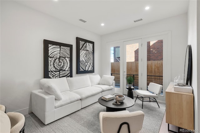 living room with recessed lighting, visible vents, and baseboards