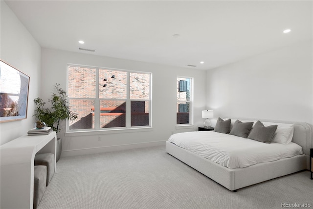 bedroom with visible vents, recessed lighting, light colored carpet, and baseboards