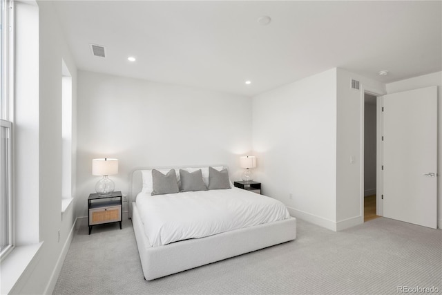 bedroom featuring light colored carpet, recessed lighting, and visible vents