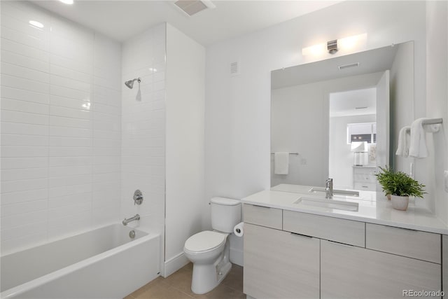 full bathroom with tile patterned flooring, toilet, vanity, and visible vents