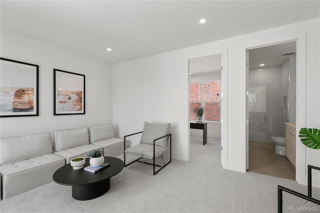 living room with recessed lighting, visible vents, light carpet, and baseboards