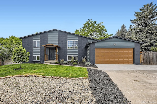 7325 Taft Ct, Arvada, CO 80005 - view of front facade featuring driveway, an attached garage, and brick siding