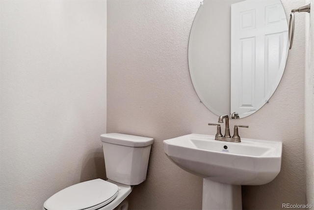 bathroom with toilet and sink