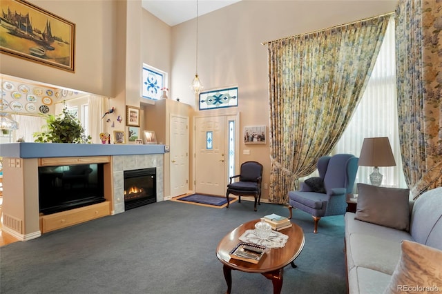 5155 W Quincy Ave Unit L101, Denver, CO 80236 - carpeted living room with a high ceiling and a tiled fireplace