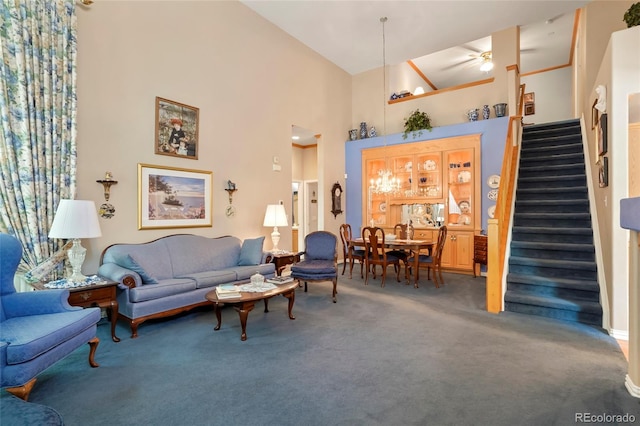 5155 W Quincy Ave Unit L101, Denver, CO 80236 - living room featuring carpet flooring, stairs, a high ceiling, and a ceiling fan