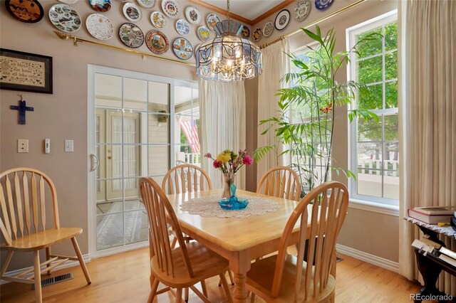 5155 W Quincy Ave Unit L101, Denver, CO 80236 - dining room featuring light wood-style floors, a chandelier, and ornamental molding