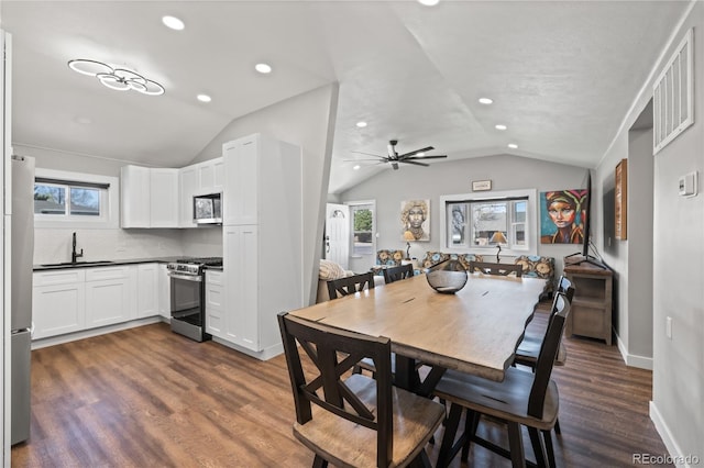 dining space with vaulted ceiling, dark wood-style floors, a healthy amount of sunlight, and recessed lighting