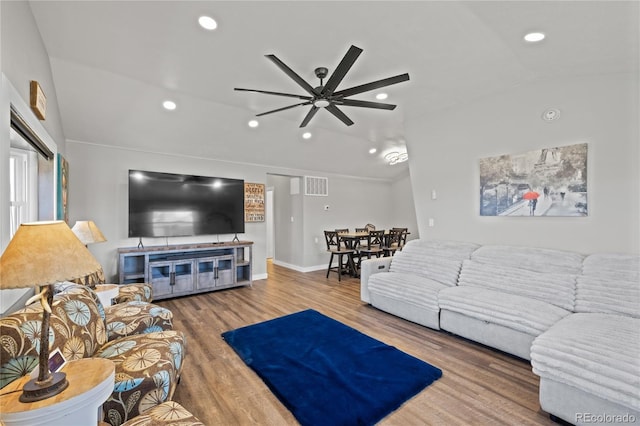 living room with lofted ceiling, recessed lighting, visible vents, ceiling fan, and wood finished floors