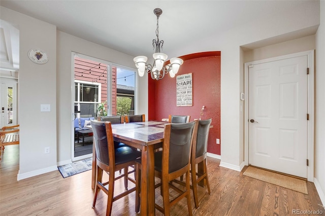 13324 W 86th Dr, Arvada, CO 80005 - dining area featuring light wood-style flooring, a chandelier, and baseboards