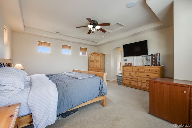 13324 W 86th Dr, Arvada, CO 80005 - bedroom with a raised ceiling, light colored carpet, arched walkways, a ceiling fan, and attic access