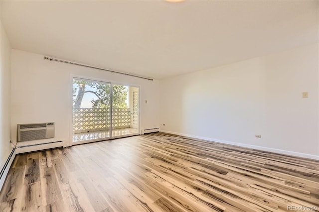 unfurnished room with light hardwood / wood-style flooring, an AC wall unit, and a baseboard radiator