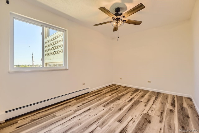 empty room featuring ceiling fan, light hardwood / wood-style flooring, plenty of natural light, and a baseboard radiator