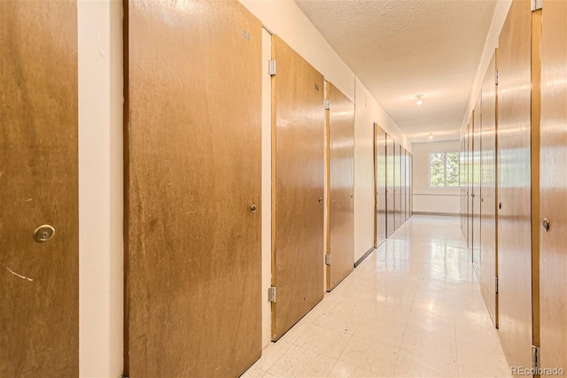 corridor featuring a textured ceiling