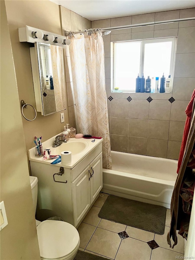 full bathroom with tile patterned floors, vanity, shower / bath combo with shower curtain, and toilet