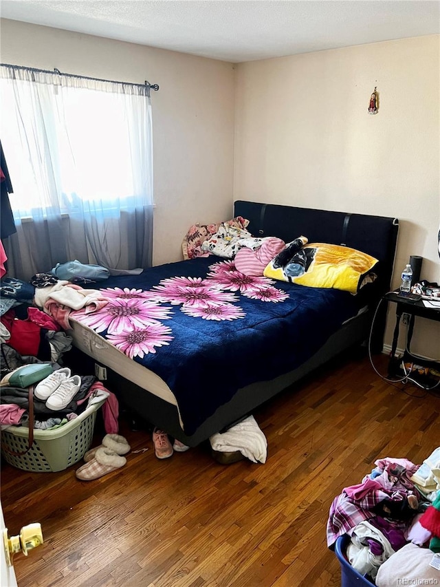 bedroom with hardwood / wood-style floors