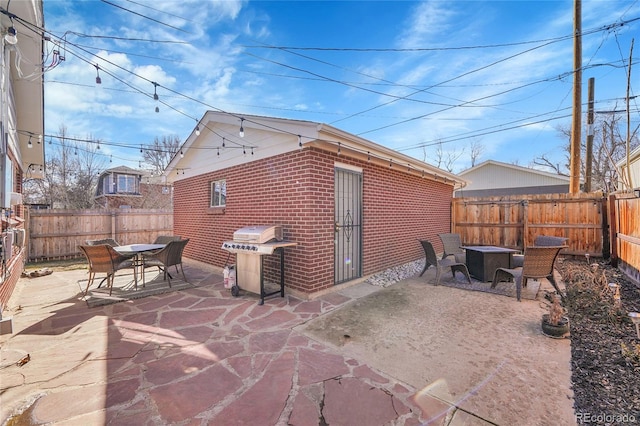 view of patio / terrace featuring grilling area and a fire pit