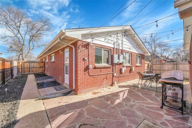 view of side of home with a patio