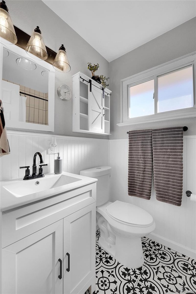 bathroom with tile patterned flooring, vanity, and toilet