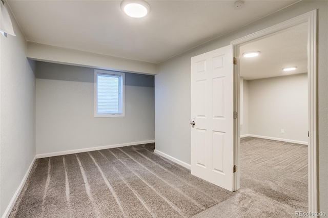 below grade area with carpet flooring and baseboards