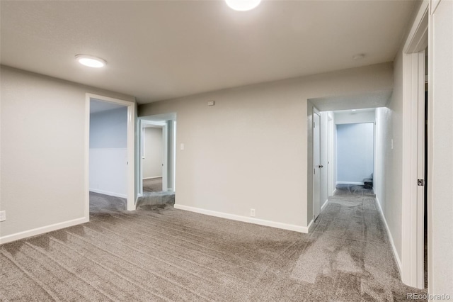 interior space featuring carpet flooring and baseboards