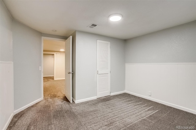 unfurnished bedroom with carpet floors, a closet, and visible vents