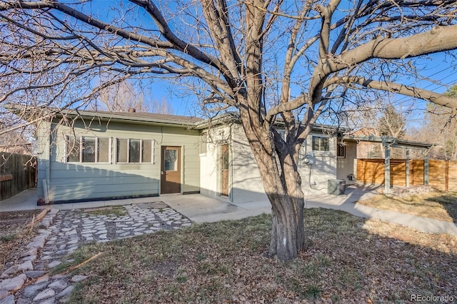 back of house featuring a patio area and fence