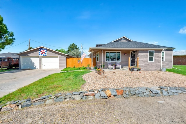 1775 Longbranch St, Strasburg, CO 80136 - view of front of house with a porch, a garage, roof with shingles, and an outbuilding