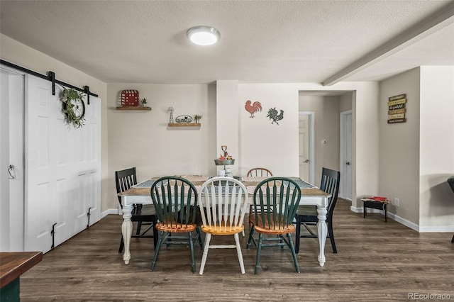 1775 Longbranch St, Strasburg, CO 80136 - dining room featuring wood finished floors, a barn door, and a textured ceiling