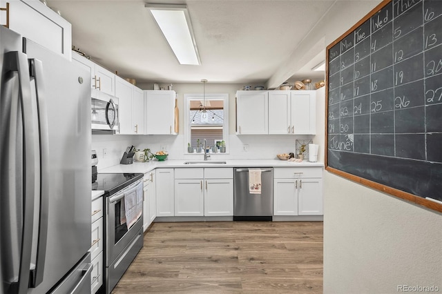 1775 Longbranch St, Strasburg, CO 80136 - kitchen featuring stainless steel appliances and white cabinetry