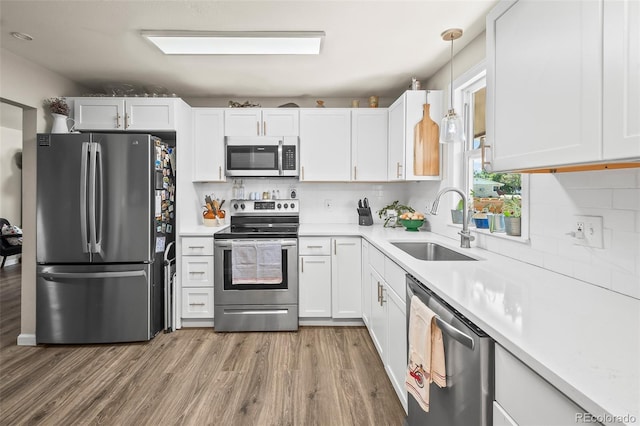 1775 Longbranch St, Strasburg, CO 80136 - kitchen featuring stainless steel appliances, light wood-style flooring, and decorative backsplash