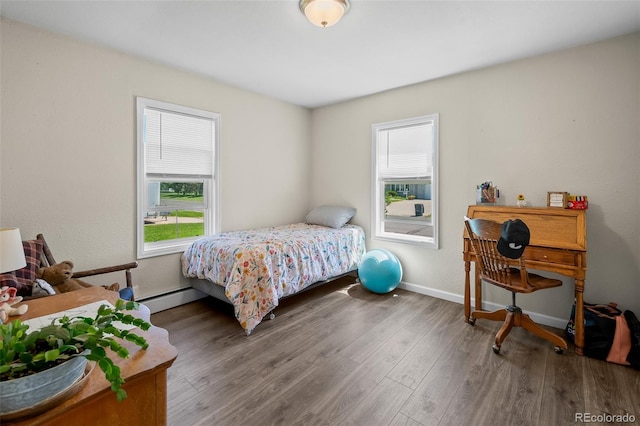 1775 Longbranch St, Strasburg, CO 80136 - bedroom featuring wood finished floors and a baseboard radiator