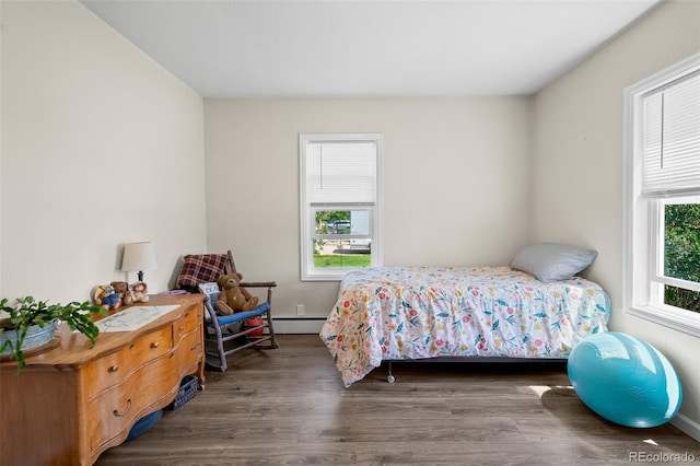 1775 Longbranch St, Strasburg, CO 80136 - bedroom with wood finished floors and a baseboard radiator