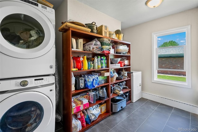 1775 Longbranch St, Strasburg, CO 80136 - laundry room with stacked washing machine and dryer, dark tile patterned flooring, and a baseboard heating unit