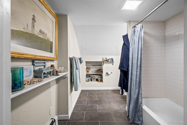 1775 Longbranch St, Strasburg, CO 80136 - full bath with tile patterned floors, shower / bathtub combination with curtain, and a textured wall
