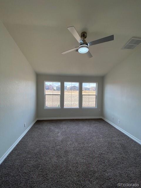 carpeted spare room featuring ceiling fan