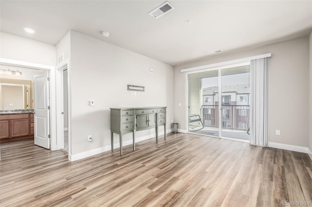 spare room featuring light hardwood / wood-style flooring