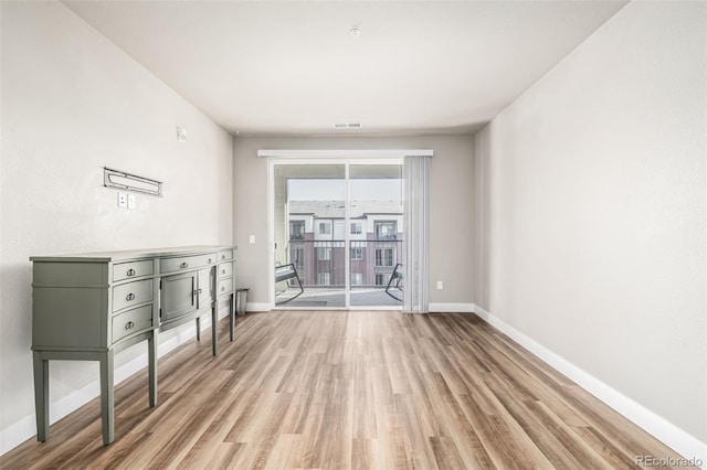 empty room with light hardwood / wood-style flooring